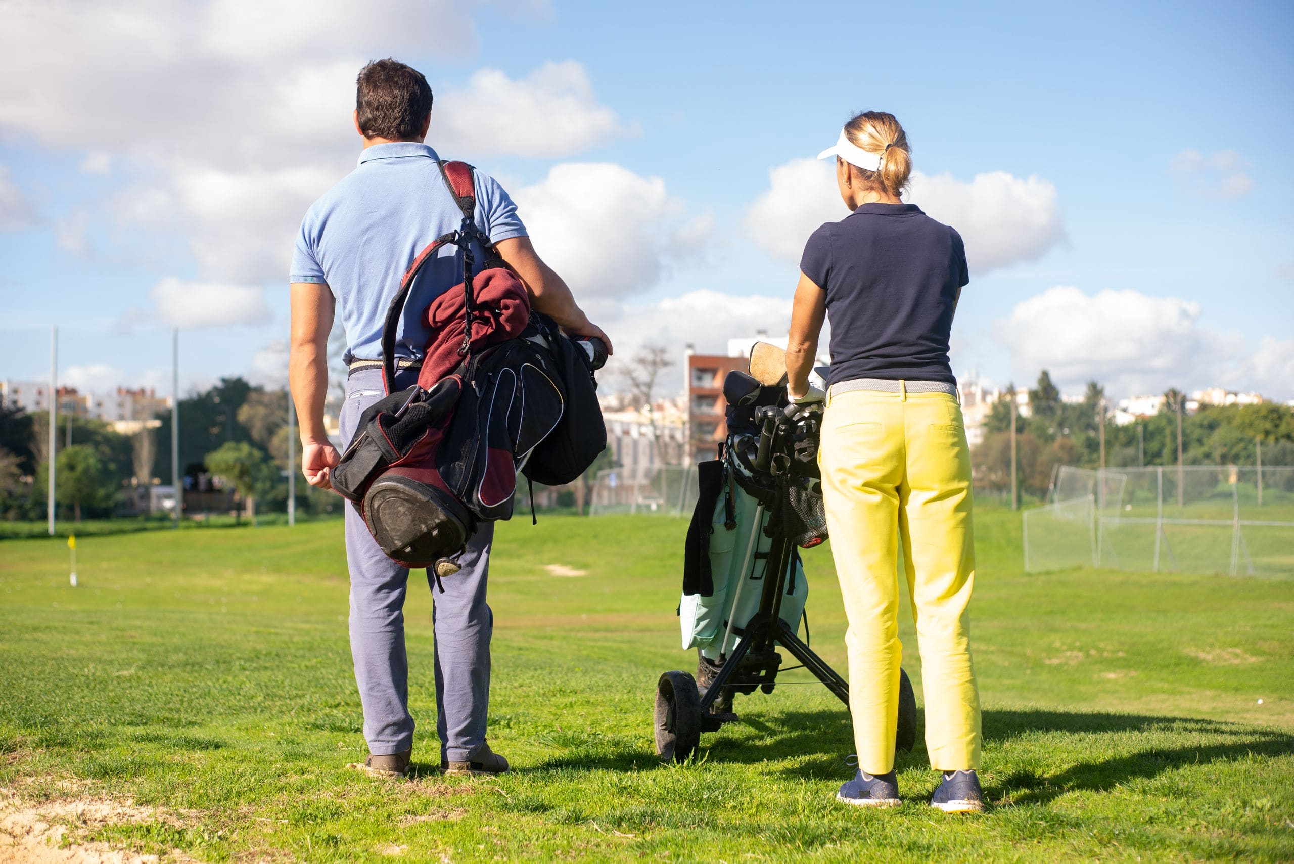 A JULY Golf arranger and a client studying a course map and itinerary together at a clubhouse table