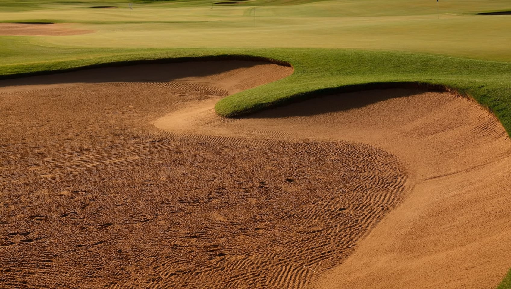 A golfer completing a full swing on a sunlit fairway with distant hills beyond